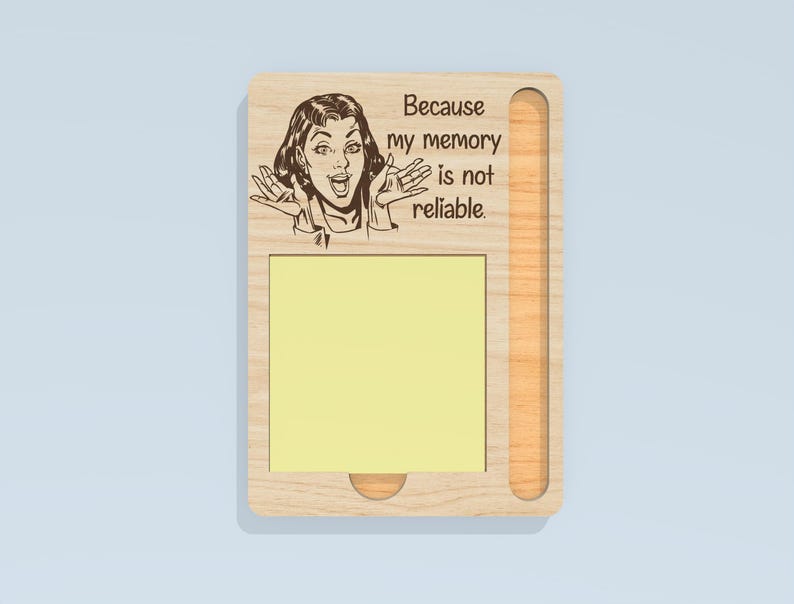 May include: Wooden memo board with a pop art style illustration of a woman and the text "Because my memory is not reliable." The board has a yellow sticky note pad and a pen holder.