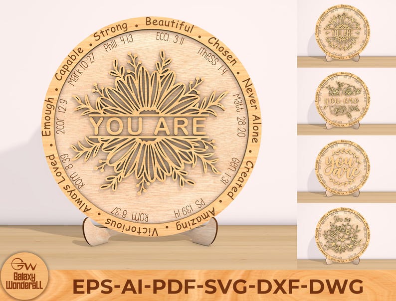 May include: A wooden round sign with a floral design and the words "YOU ARE" in the center. The sign is surrounded by a circle of words and bible verses, including "Strong", "Capable", "Beautiful", "Chosen", "Never Alone", "Created", "Amazing", "Victorious", "Always Loved", "Enough".