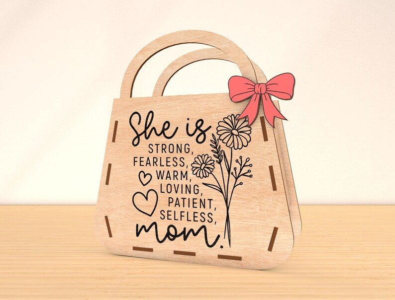 May include: Wooden handbag-shaped sign with the text "She is strong, fearless, warm, loving, patient, selfless, mom!" and a floral design.