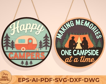 May include: Two round wooden signs with camping themes. One says "Happy Campers" with a camper illustration. The other says "Making Memories One Campside at a Time" with a tent and two figures. Both signs are hanging by twine.