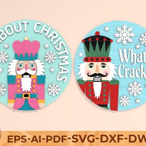 May include: Two circular Christmas designs with nutcracker soldiers and snowflakes. One says "Nuts About Christmas" and the other says "What's Crackin?" Both are on a light blue background. The bottom of the image shows file formats.