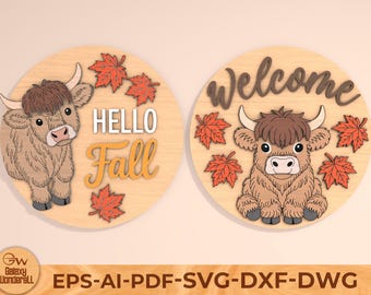 May include: Two round wooden signs with a Highland cow design. One sign says "Hello Fall" and the other says "Welcome". Both signs have orange maple leaves. The signs are light brown with a light brown cow.