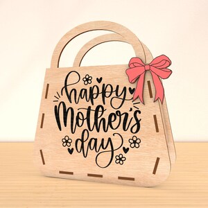 May include: Wooden handbag with a pink bow and the text "Happy Mother's Day" in black script.