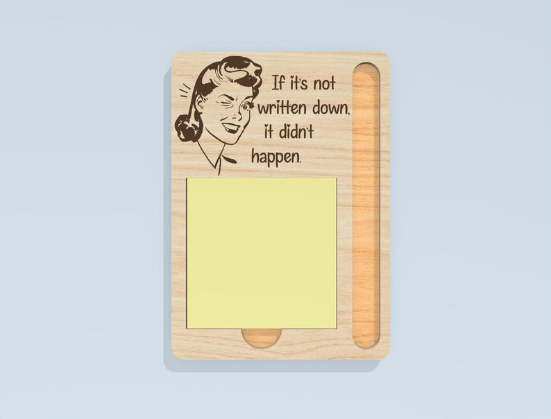 May include: Wooden memo board with a retro illustration of a woman and the text "If it's not written down, it didn't happen." The board has a slot for a notepad and a small, round cutout at the bottom.