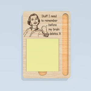 May include: Wooden sticky note holder with a retro illustration of a woman giving a thumbs up. The text reads "Stuff I need to remember before my brain deletes it." Includes a yellow sticky note pad.