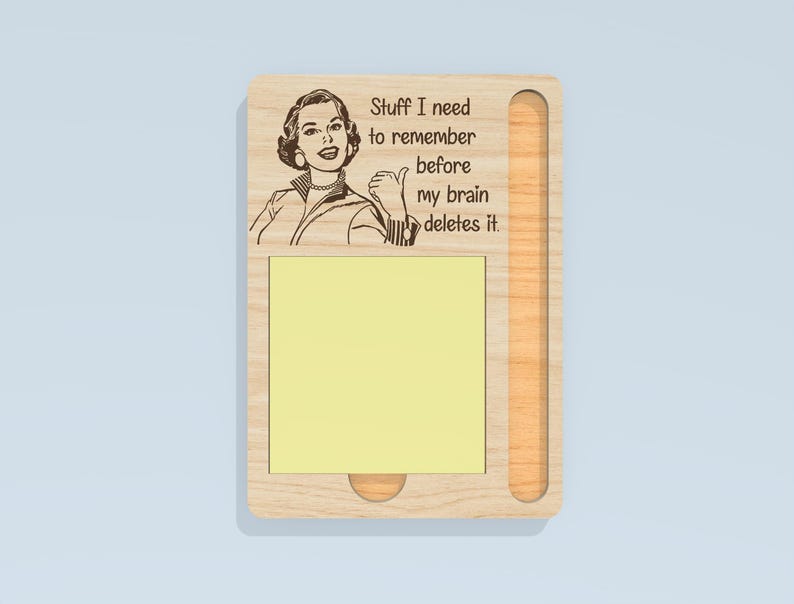 May include: Wooden sticky note holder with a retro illustration of a woman giving a thumbs up. The text reads "Stuff I need to remember before my brain deletes it." Includes a yellow sticky note pad.