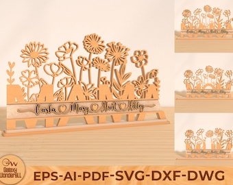 May include: A wooden cutout of a floral design with the names Carla, Mary, Hunt, and Kelley written below. The cutout is on a wooden base and is ready to be personalized.