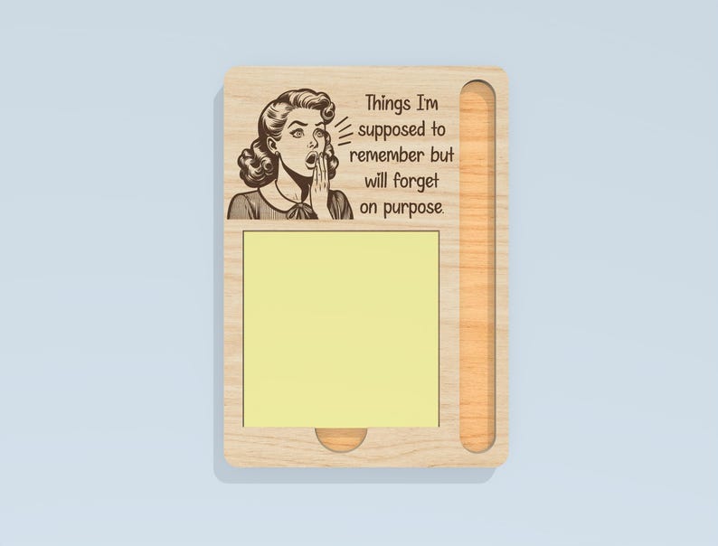 May include: Wooden memo board with a retro illustration of a woman and the text "Things I'm supposed to remember but will forget on purpose." Includes a yellow sticky note pad and a pen holder.