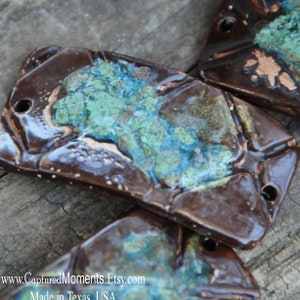 Cuff bead with deep greens and brown and a texture of a mineral