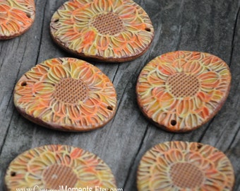 Handmade Pottery Bead in multi tones of orange and yellow with a sunflower design