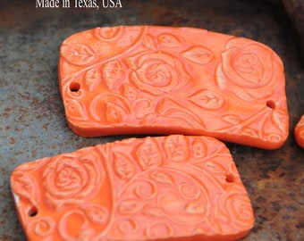 Pottery bead perfect for a cuff bracelet in orange in a rose design