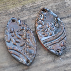 2 Handmade Pottery Beads in Bronze with a folk design