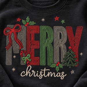 May include: A black crewneck sweatshirt featuring embroidered text that reads MERRY in large, multi-colored stitched letters and christmas in cursive script. The design includes a red bow, a candy cane, a green pine tree, and holly leaves.