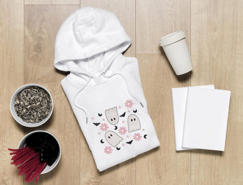 May include: White hooded sweatshirt with a print of pink flowers, white ghosts, and black bats.