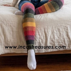 May include: A set of three ceramic mugs with a speckled, cream-colored glaze. Each mug features a different hand-painted floral design in shades of blue, green, and yellow. The mugs have a simple, rounded shape and a comfortable handle.