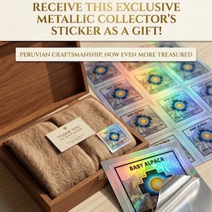 May include: A tan textile item inside a wooden box, accompanied by a thank you card and a sheet of square metallic stickers. Each sticker features a colorful geometric sun design, the text BABY ALPACA, and a holographic finish.
