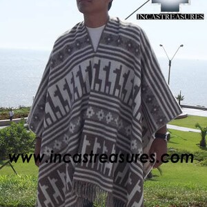May include: A gray and white poncho with a geometric pattern featuring llama figures and striped borders. The poncho has a fringed hem and is worn outdoors. The logo "INCASTREASURES" is visible in the upper right corner.