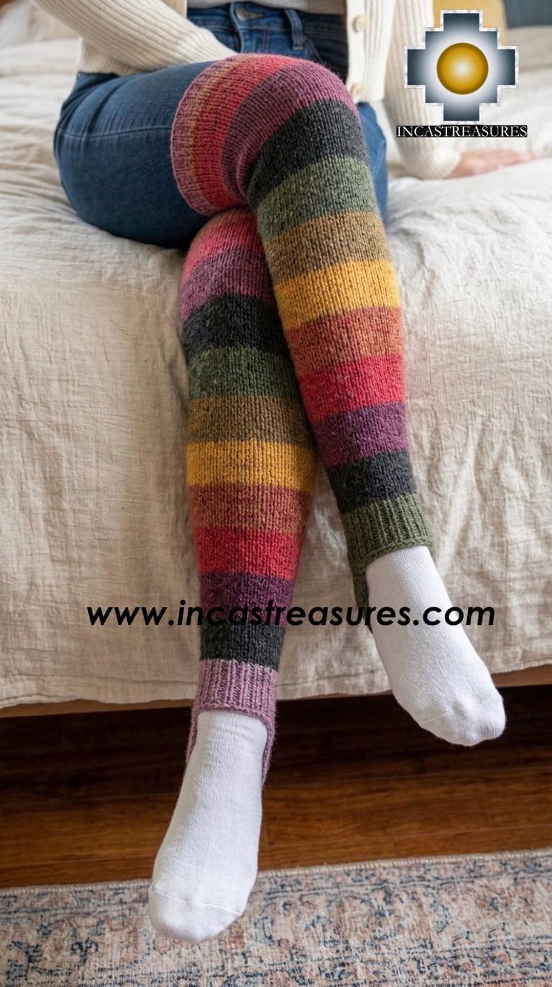 May include: Thigh-high stirrup leg warmers featuring horizontal stripes in shades of red, yellow, green, purple, and charcoal gray. The knit fabric has a ribbed texture at the top and bottom openings. The text www.incastreasures.com is visible.