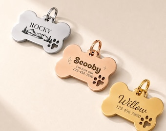 May include: Three bone-shaped pet ID tags in silver, rose gold, and gold tones. Each tag features a metal jump ring, a paw print cutout, and custom engravings: Rocky with a mountain graphic, Scooby with contact info, and Willow with a phone number.