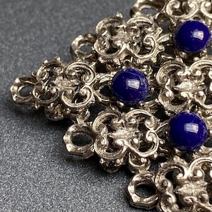 Vintage, very collectible, 1950s Fischland Schmuck Austria, silver tone and lapis blue glass brooch with a rollover clasp, and fish logo