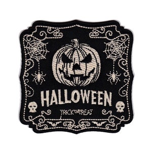 May include: Black and white embroidered iron-on patch with a spooky Halloween design. It features a jack-o-lantern with a scary face, spiders, spiderwebs, and the text "HALLOWEEN TRICK OR TREAT". The patch is 3 inches by 3 inches.