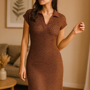 May include: A brown, short-sleeved, crochet dress with a collared neckline and a V-neck. The dress has a fitted silhouette and a scalloped hemline. The model is wearing the dress in a well-lit room.