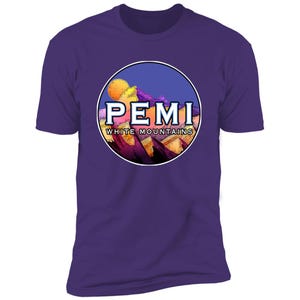 May include: Purple t-shirt with a circular graphic of a mountain range with a sunset and the text "PEMI WHITE MOUNTAINS".