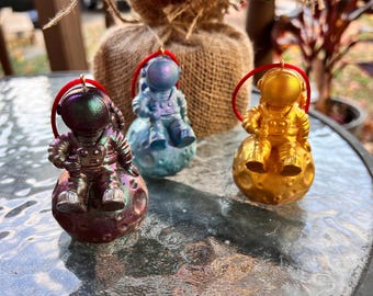 resin astronaut sitting on the moon Christmas ornament