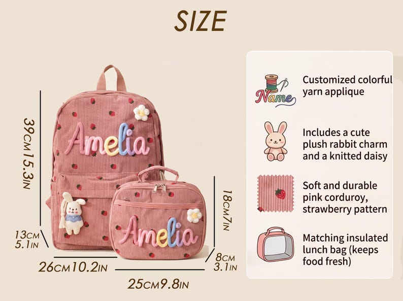 May include: A pink corduroy backpack and matching lunch bag with a strawberry pattern, featuring the name Amelia in colorful yarn applique, a plush rabbit charm, and a knitted daisy. The backpack measures 15.3 inches by 10.2 inches by 5.1 inches.
