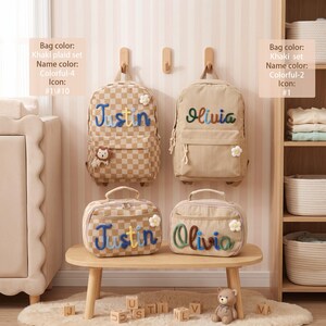May include: Two khaki backpacks and two matching lunch bags featuring embroidered names Justin and Olivia. The Justin items have a checkered pattern and a lion icon, while the Olivia items are solid khaki with a flower icon and colorful lettering.