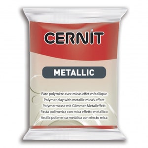May include: A rectangular package of Cernit Metallic polymer clay. The top section is red with the white brand name CERNIT. The center features a dark gray horizontal bar with the word METALLIC in white. The lower section is beige with text.