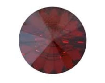 May include: A single, round, red crystal rhinestone with a faceted design.