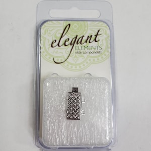 May include: Silver tone double strand connector with a decorative design. The connector is packaged in a clear plastic clamshell with a white foam insert. The packaging has the text "elegant ELEMENTS elite components".