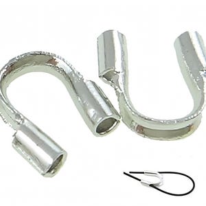 May include: Two silver-toned metal crimp end caps for jewelry making. The caps are shaped like a U with a small hole at the top. The caps are used to secure the ends of cords or chains.