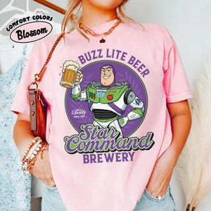 May include: A white ceramic mug with a black handle and the text "But First, Coffee" in a handwritten style. The mug is on a white surface. The mug is approximately 4 inches tall.