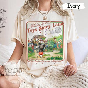 May include: A white ceramic mug with a black handle and the text "But First, Coffee" in a black, handwritten-style font. The mug is on a white surface.