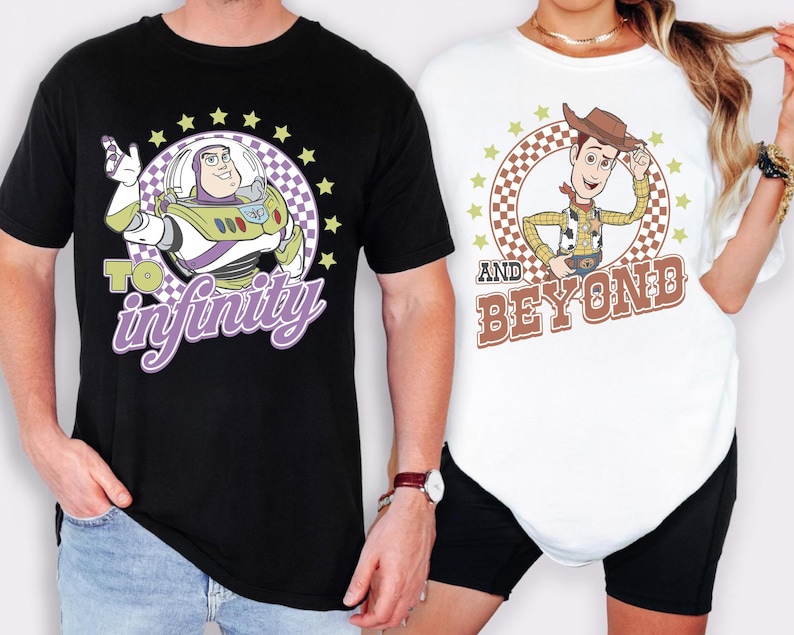 May include: Black and white t-shirts featuring cartoon characters Buzz Lightyear and Woody from Toy Story. Buzz Lightyear's shirt says "To Infinity" and Woody's shirt says "And Beyond". Both shirts have a circular design with stars.