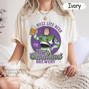 May include: A white ceramic mug with a black handle and the text "But First, Coffee" in a bold, black font. The mug is set against a blurred background, suggesting a cozy setting.