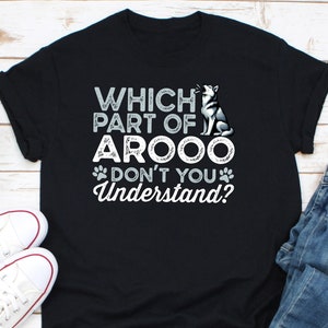May include: Black t-shirt with the text "WHICH PART OF AROOO DON'T YOU Understand?" and a graphic of a husky dog. The design includes paw prints and a husky dog howling.