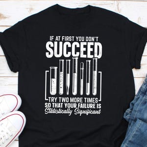 May include: Black t-shirt with a white graphic of test tubes and the text "If at first you don't succeed, try two more times so that your failure is statistically significant."