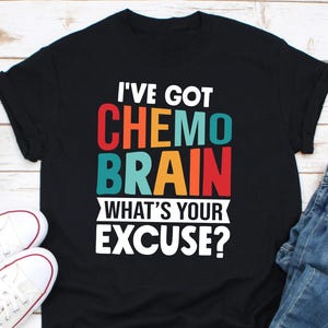 May include: Black t-shirt with a colourful graphic that says "I've got chemo brain what's your excuse?"