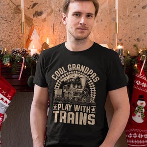 a man standing in front of a christmas tree
