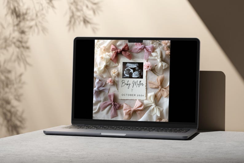 May include: A laptop screen displaying a digital announcement for a baby shower. The announcement features a black and white ultrasound image, pink and white bows, and the text "Baby Miller, October 2023".