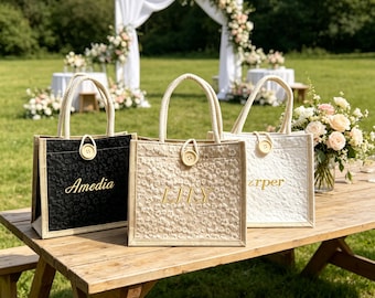 May include: Three square tote bags with rope handles and a single button closure. The black bag features the name Amedia, the beige bag features the name LILY, and the white bag features the name Harper, all embroidered in gold script lettering.