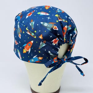 Space surgical cap with tie back for men. Rocket skull tie-back style surgical scrub hat.