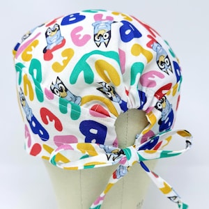 Dog surgical cap with tie back for men. Cartoon skull tie-back style surgical scrub hat.