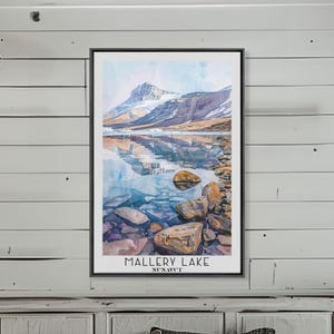 May include: A watercolor painting of a mountain lake with a mountain reflected in the water. The lake is surrounded by rocks and the water is a light blue color. The text "Mallery Lake Nunavut" is at the bottom of the painting.