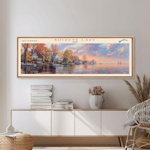 May include: A vintage-style illustration of Buckeye Lake, Ohio, featuring a scenic view of the lake with houses and trees along the shore. The sky is a vibrant orange and pink, with clouds reflecting in the water. The text "Buckeye Lake, Ohio" is displayed at the top of the image.