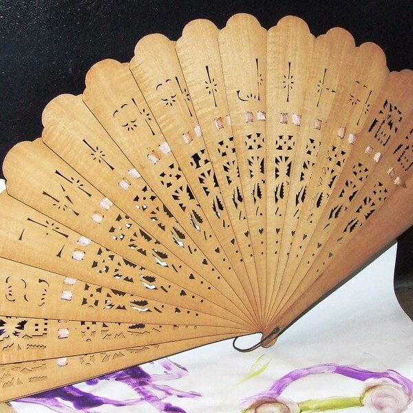 WWII Era Wooden die cut hand Fan from the Philipines well used with a Pink Silk Ribbon decor and the users world travels penciled in