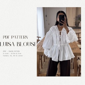 May include: A white blouse with a gathered neckline and a tie at the front. The blouse has long, puffy sleeves and a loose fit. The text "PDF PATTERN LUISA BLOUSE" is at the top of the image. The text "PPDF SEWING PATTERN 0 sizes 32-50 EU Size Formats: A4, AO US Letter" is at the bottom of the image.